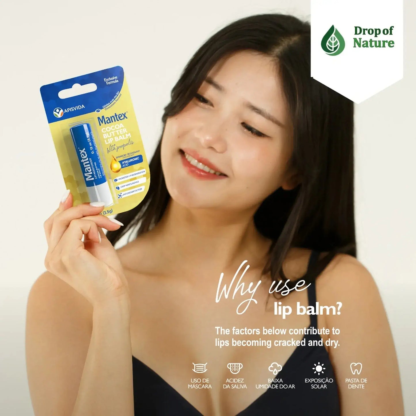 Lip balm packaging featuring a blue label with yellow accents, displayed by a smiling person on a light background.