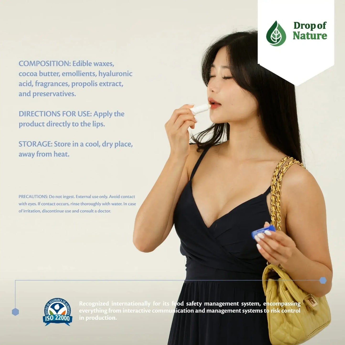 Woman applying lip balm from a white tube, wearing a dark dress, with instructional text and a green leaf logo in the background.