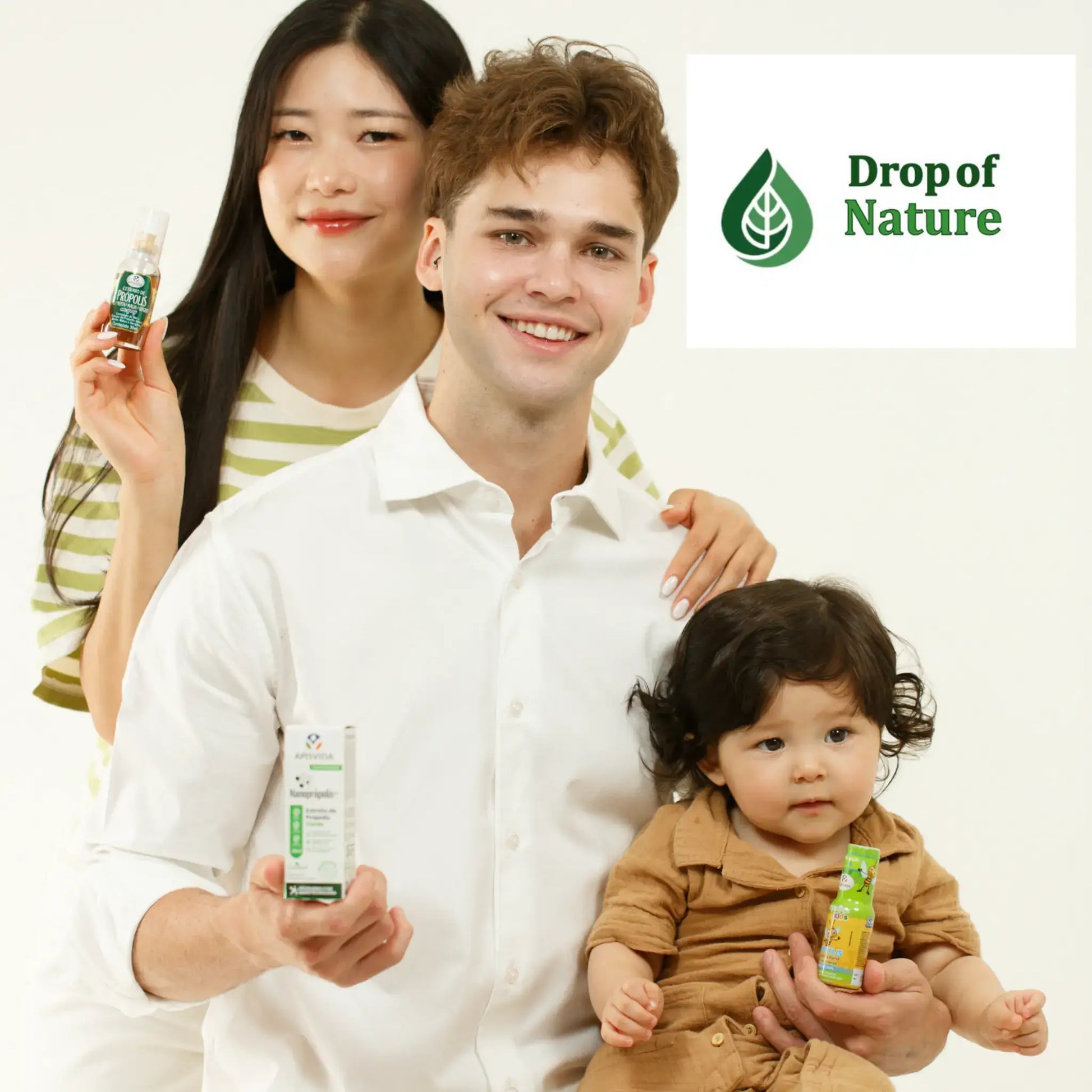 A man holding a white box, a woman showcasing a green bottle, and a toddler with a yellow packaging, all smiling against a light background.